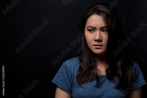 Scared woman on isolated black background