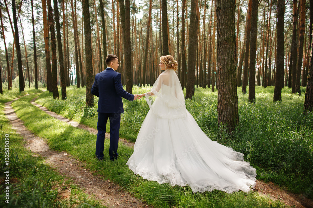 Weeding couple walking in the forest after wedding ceremony Weeding couple walking in the forest after wedding ceremony