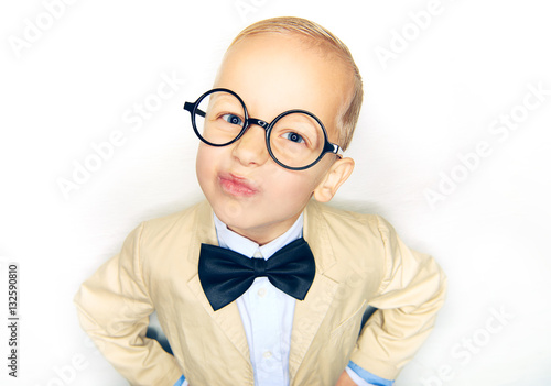 Little boy in suit making funny faces