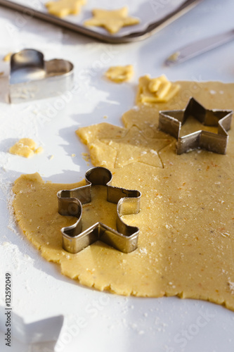 Making Christmas Biscuits with Gingerbread Man, Star and Heart Cookie Cutters on White Table