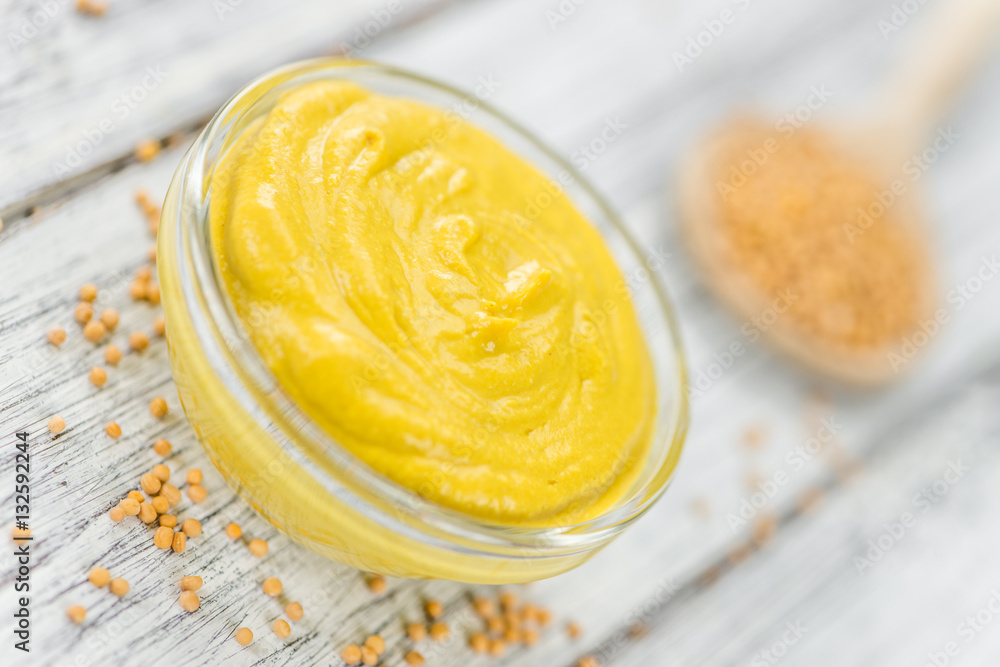 Fresh made Mustard on a rustic background Fresh made Mustard on a rustic background