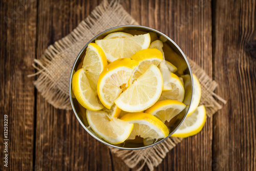 Lemon (sliced) on wooden background (selective focus)
