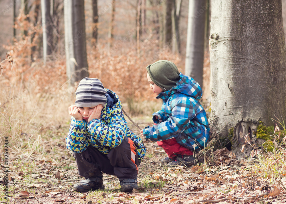 Naklejka premium Tired or bored child in forest