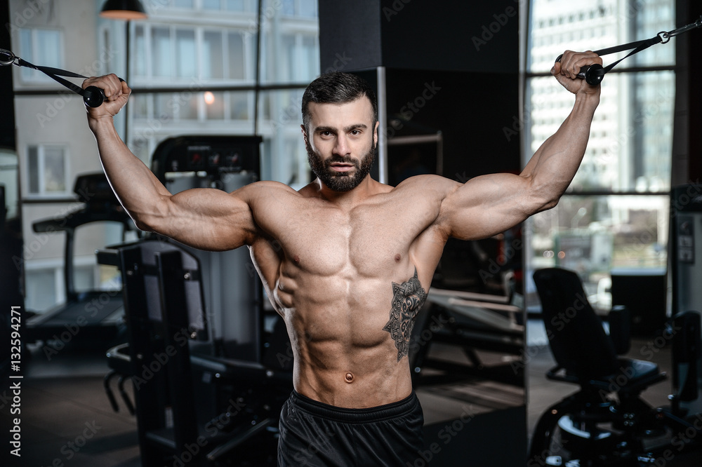 Fitness instructor handsome man in the gym gain muscle Fitness instructor handsome man in the gym gain muscle