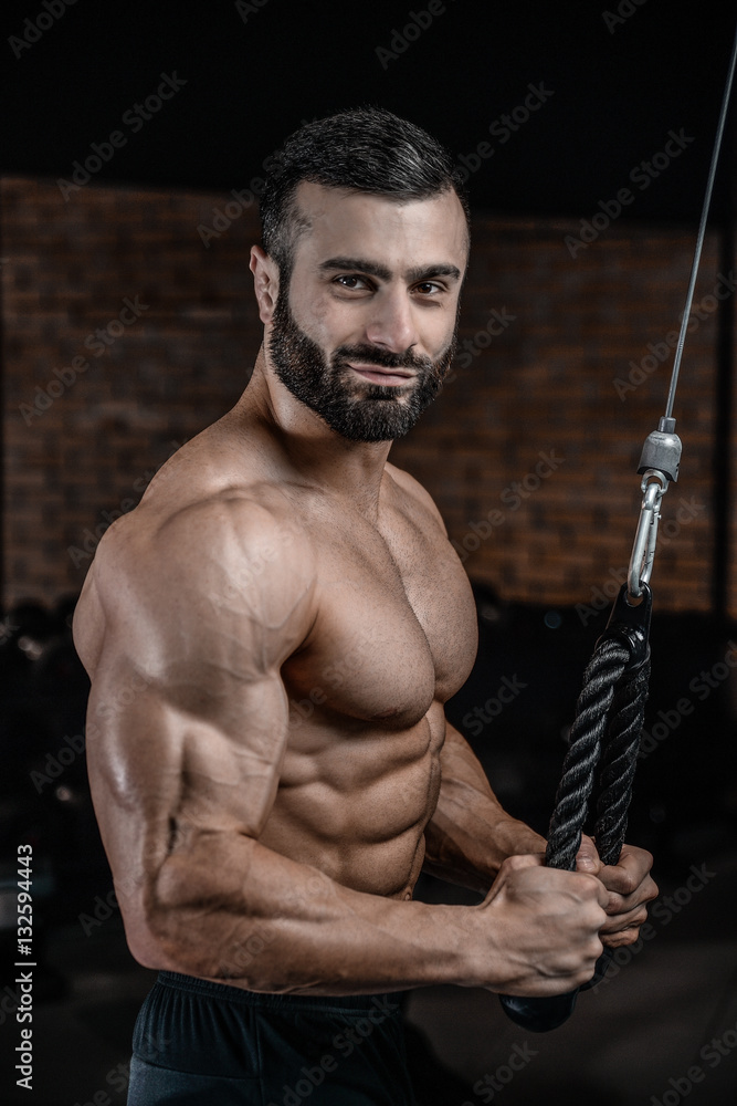 Fitness instructor handsome man in the gym gain muscle Fitness instructor handsome man in the gym gain muscle