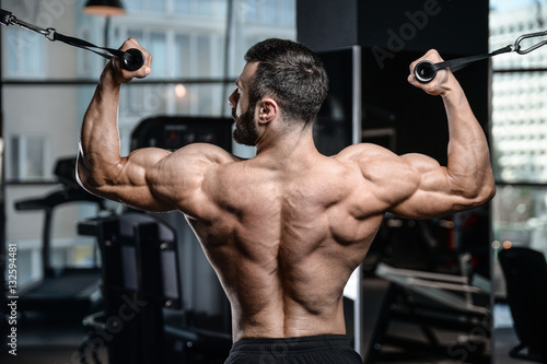 Fitness instructor handsome man in the gym gain muscle