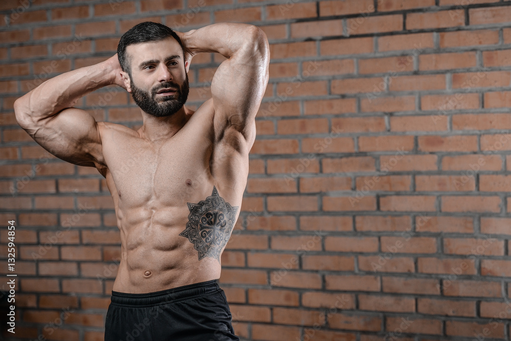 Fototapeta premium Fitness instructor handsome man in the gym gain muscle