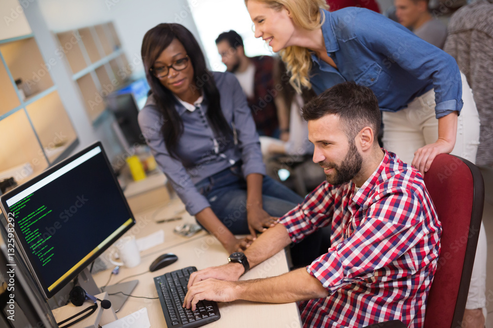 Coworkers working on project together in office Coworkers working on project together in office