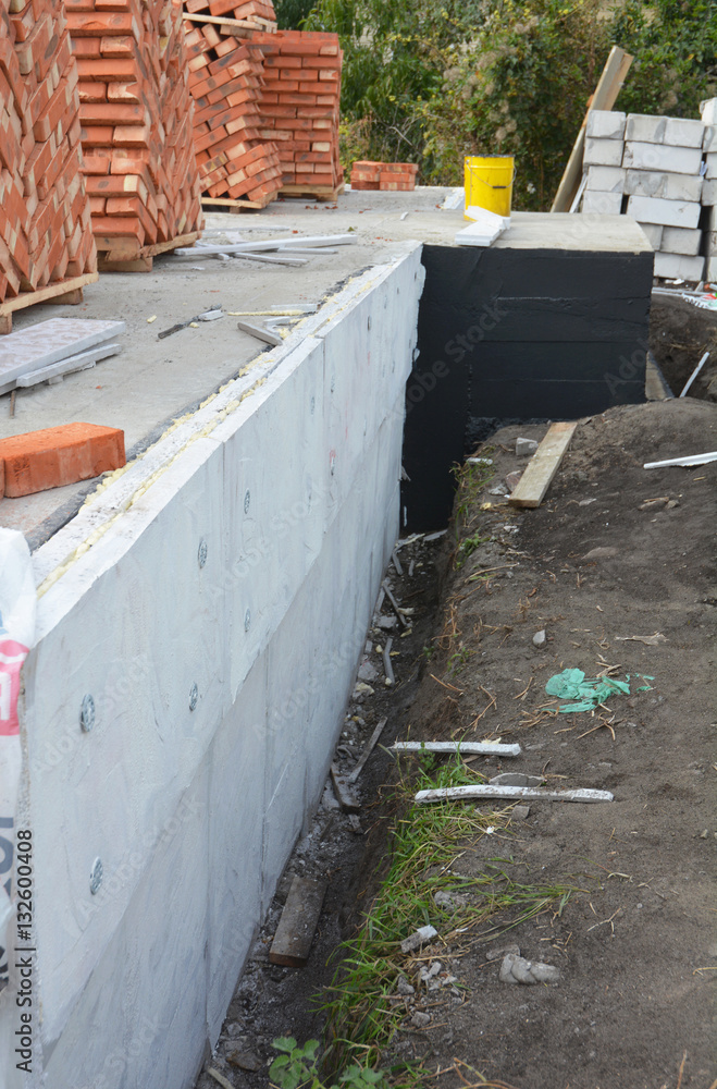 Passive house foundation insulation with polystyrene foam boards for House Energy Saving and Energy Efficiency. Damp proofing Coatings.Waterproofing house foundation with spray on tar. Passive house foundation insulation with polystyrene foam boards for House Energy Saving and Energy Efficiency. Damp proofing Coatings.Waterproofing house foundation with spray on tar.