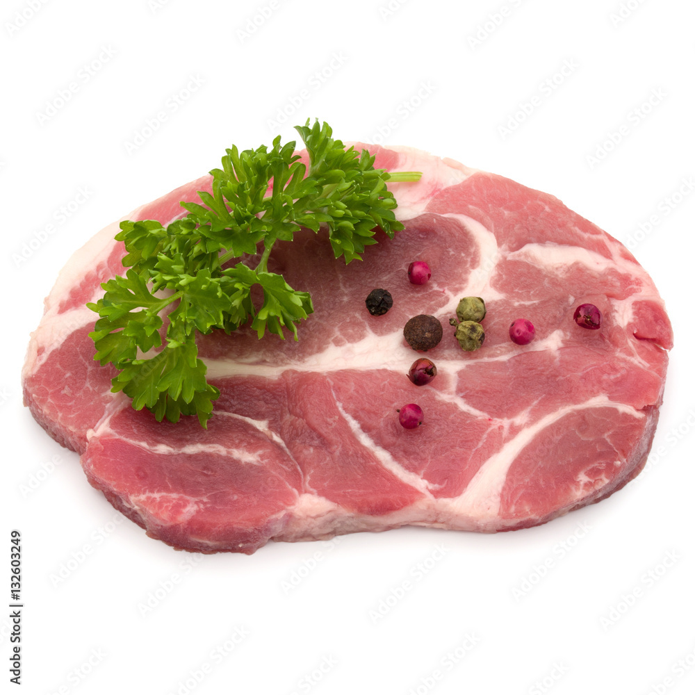 Raw pork neck chop meat with parsley herb leaves and peppercorn Raw pork neck chop meat with parsley herb leaves and peppercorn