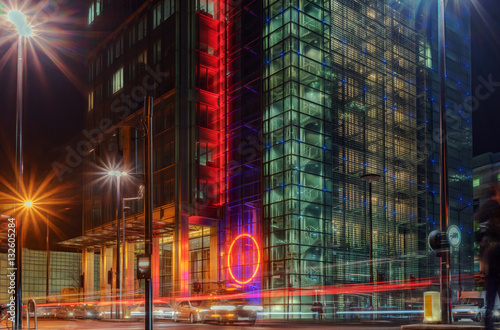 Downtown financial district setting with passing cars as light trails