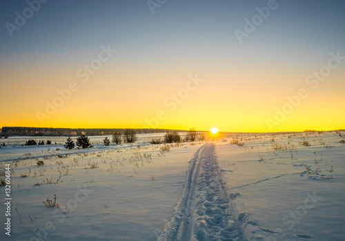 Sunset over snow-covered field
