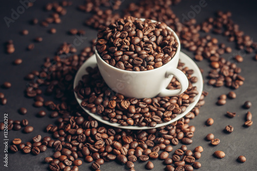 coffee beans in a mug and saucer