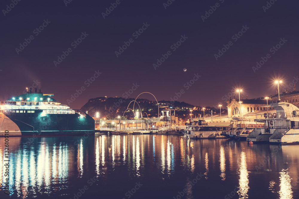 beautiful harbor at barcelona with ships and moon in the background
