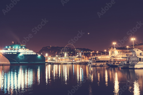 beautiful harbor at barcelona with ships and moon in the background © Robert Herhold