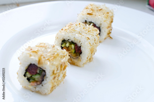 Close up of tasty fresh sushi rolls on plate