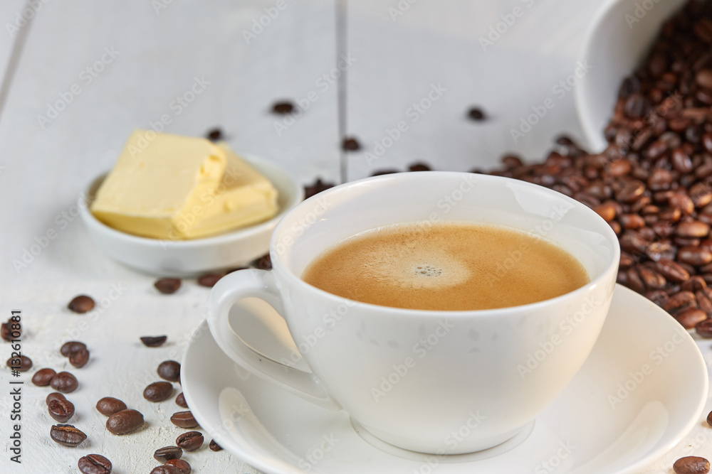 Bulletproof coffee in white cup with butter Bulletproof coffee in white cup with butter