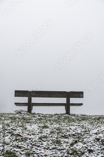 Bench empty seat in wood trees winter and fog 11