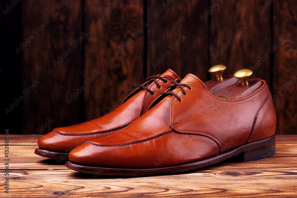 Fashionable leather derby shoes for men on wooden background Fashionable leather derby shoes for men on wooden background