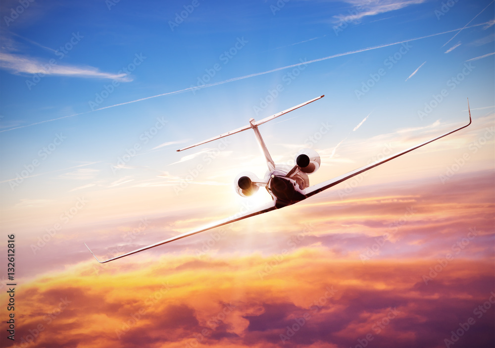 Fototapeta premium Private jet plane flying above clouds