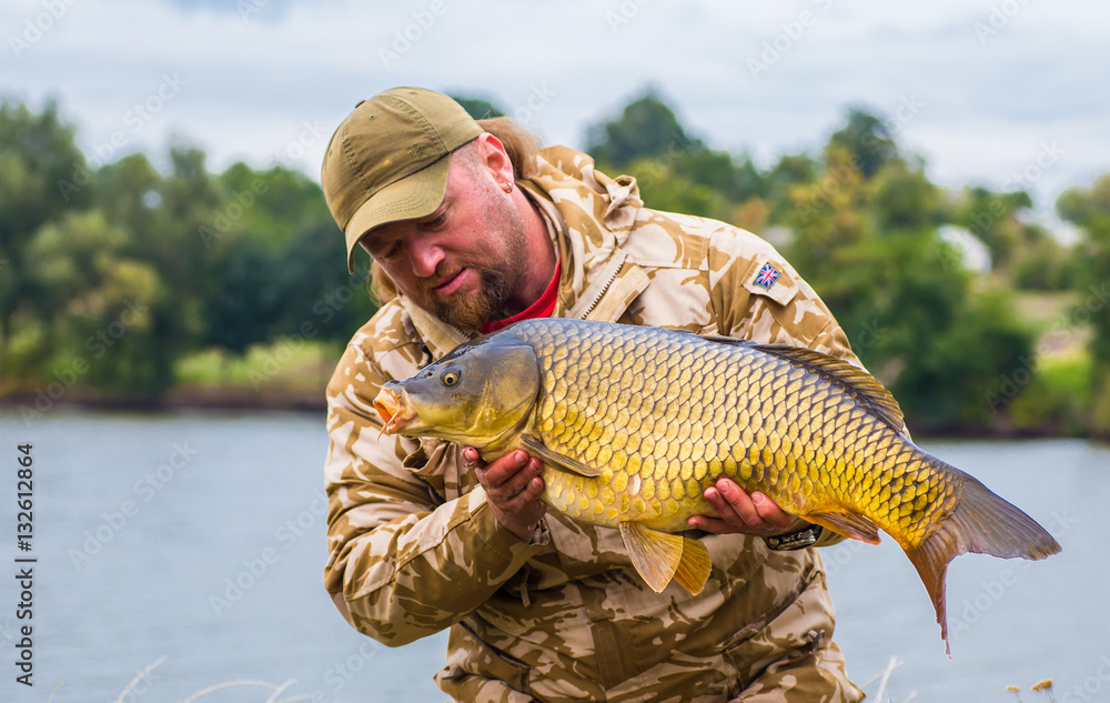 Naklejka premium Carp and Fisherman, Carp fishing trophy.
