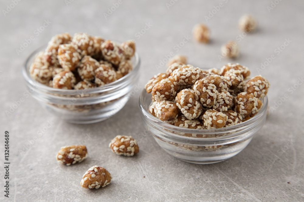 Caramel Coated Peanut with Sesame on Stone Background Caramel Coated Peanut with Sesame on Stone Background