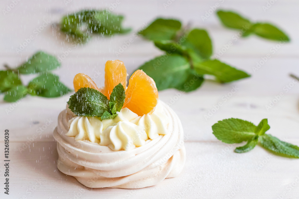 Pavlova meringue cake with fresh berries and mint on white background. Pavlova meringue cake with fresh berries and mint on white background.