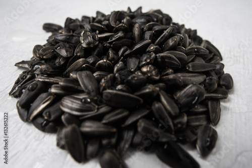 Black sunflower seeds on a white background