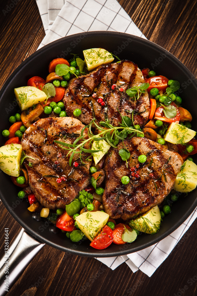 Grilled steak, baked potatoes and vegetables Grilled steak, baked potatoes and vegetables