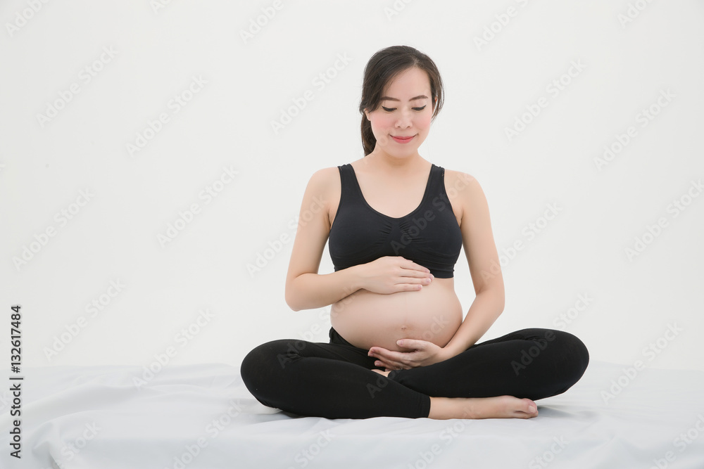 Pregnant Woman Sitting and Patting Her Belly Pregnant Woman Sitting and Patting Her Belly