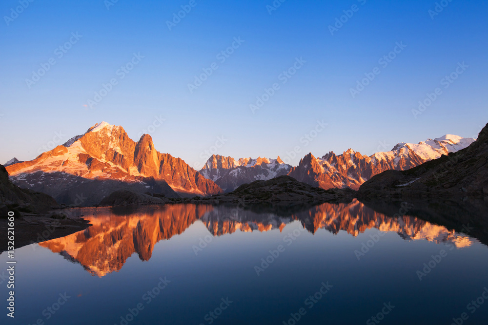 beautiful nature background, mountain landscape at sunset, panoramic view of Alps with reflection in lake