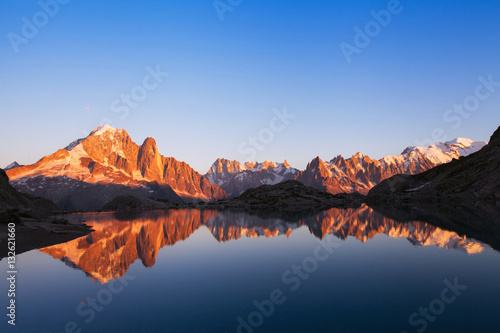 beautiful nature background, mountain landscape at sunset, panoramic view of Alps with reflection in lake © Song_about_summer