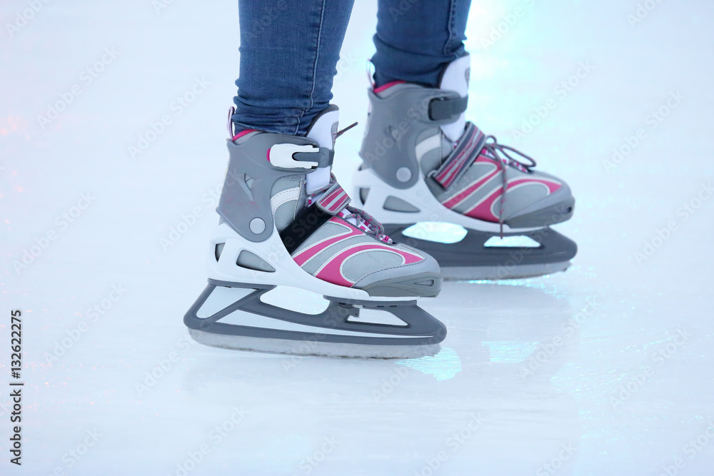 the legs of a man skating on an ice rink the legs of a man skating on an ice rink