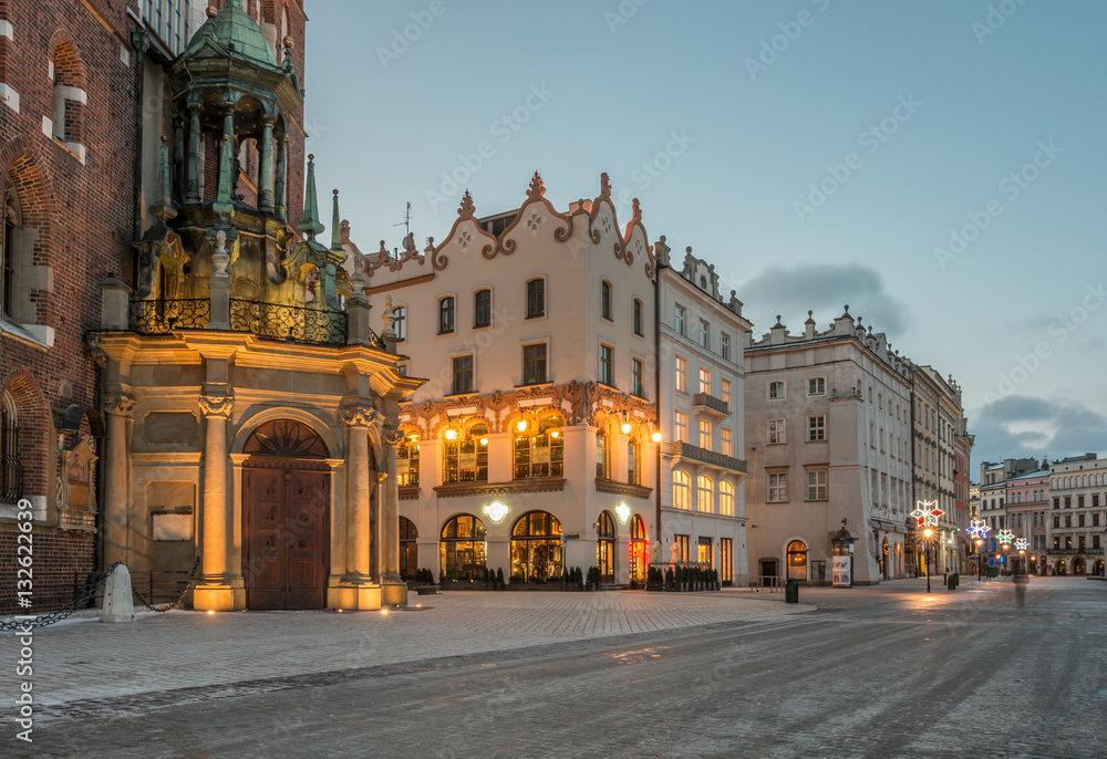 Krakow, Poland, St Mary's church and houses on Main Market square in the morning