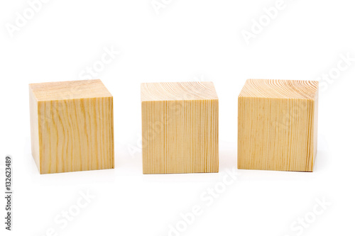 Three brown wooden cubes lined up