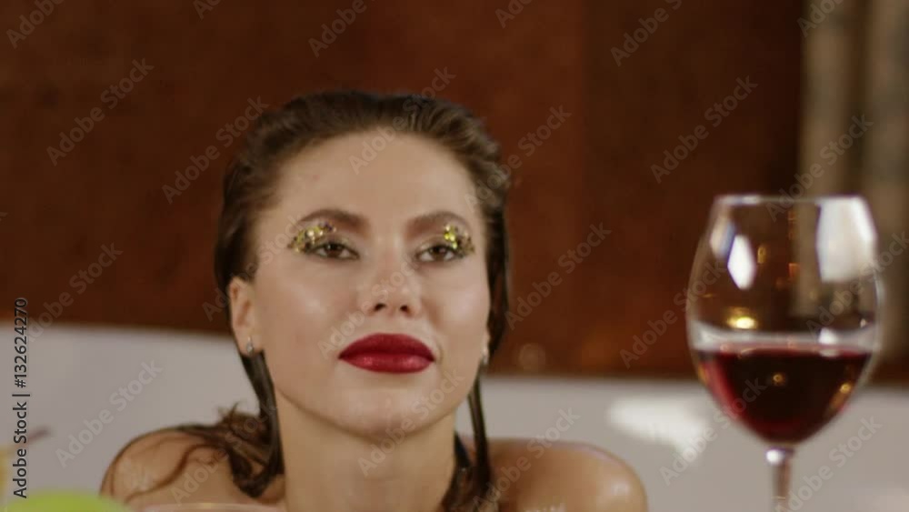 close up slow motion view of girl with bright cosmetics sitting in bath close up slow motion view of girl with bright cosmetics sitting in bath