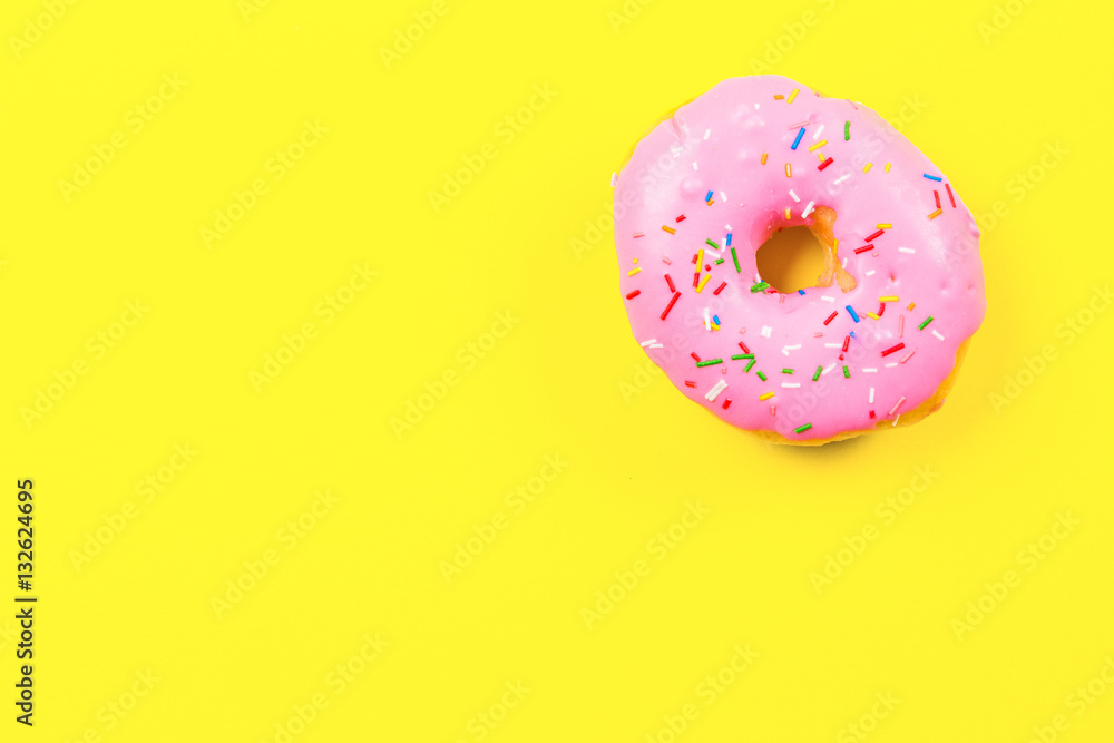 Pink round donut on yellow background. Flat lay, top view. Pink round donut on yellow background. Flat lay, top view.