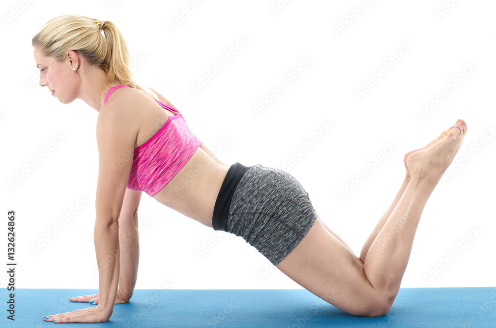 Woman making pilates mat exercises Woman making pilates mat exercises