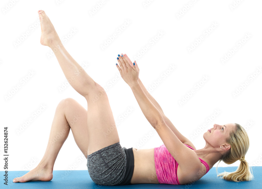 Woman making pilates mat exercises Woman making pilates mat exercises