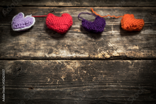 Valentine s Day. Colorful knitted hearts. Red heart on the dark old boards. Valentines day. Heart pendant. Red heart. Valentine cards. Space for text. Eighth of March. International Women s Day.