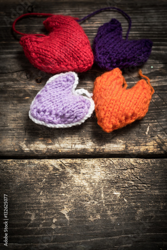 Valentine s Day. Colorful knitted hearts. Red heart on the dark old boards. Valentines day. Heart pendant. Red heart. Valentine cards. Space for text. Eighth of March. International Women s Day.