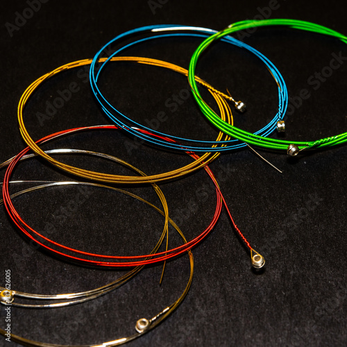 multicolor guitar strings, on dark grey background