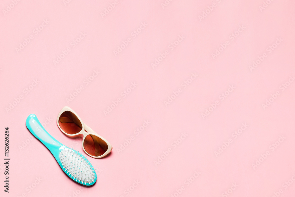 Minimalistic composition of hairbrush and eyeglasses on pink copy space. Minimalistic composition of hairbrush and eyeglasses on pink copy space.