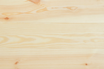 Fresh knotted pine wood planks background top view. Visible texture with natural patterns.
