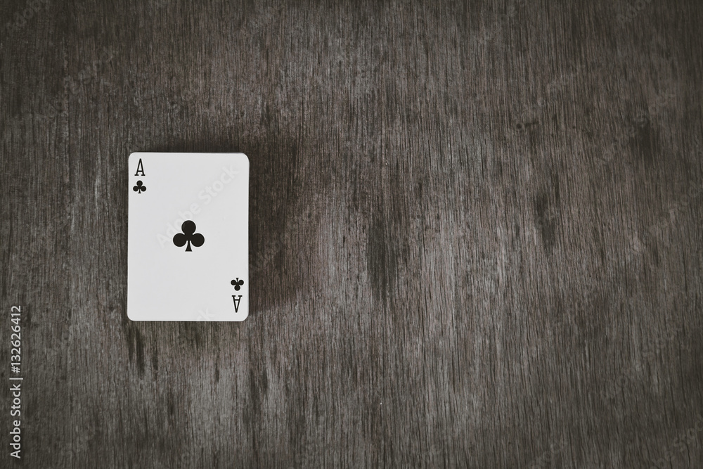 ace of clubs. playing cards on a wooden background. Risk and Gambling background, abstract and game concept. space for text.