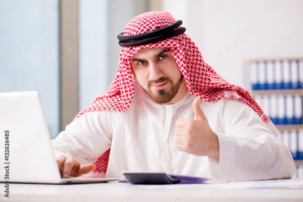 Arab businessman working on laptop computer Arab businessman working on laptop computer