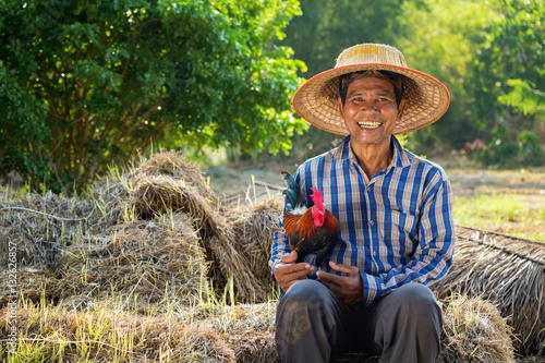 Farmer and his chicken photo