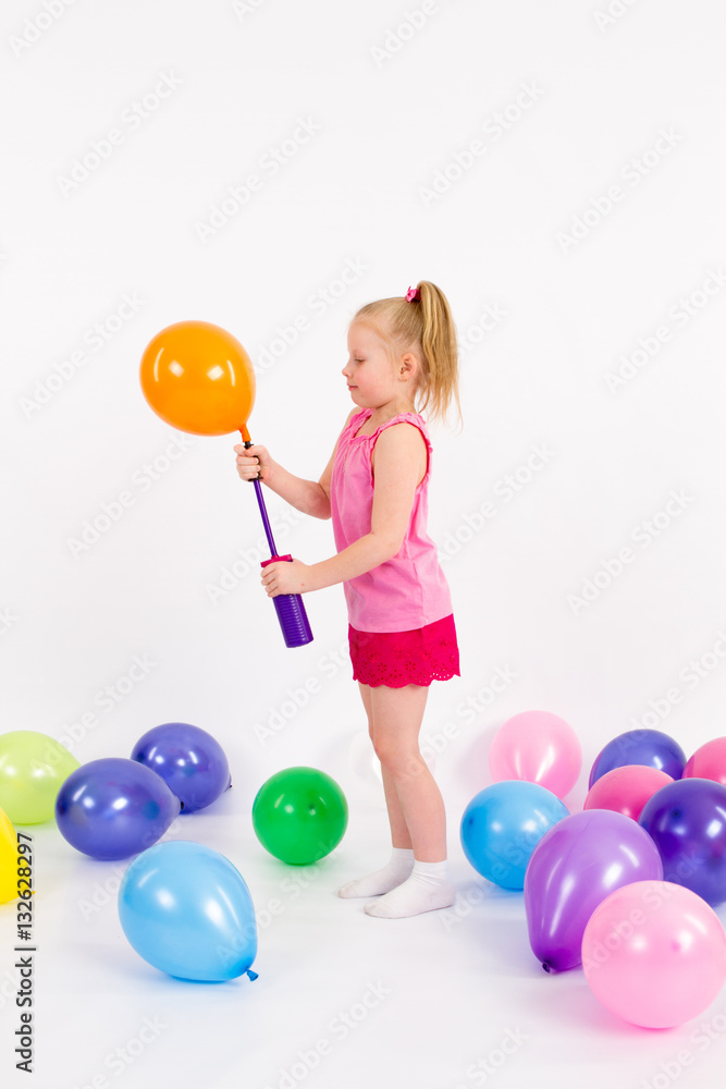 The little girl inflates the Balloon on the White Background The little girl inflates the Balloon on the White Background