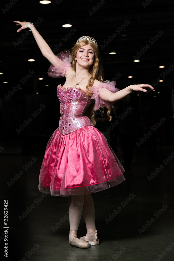 Young woman cosplayer wearing pink dress posing Young woman cosplayer wearing pink dress posing