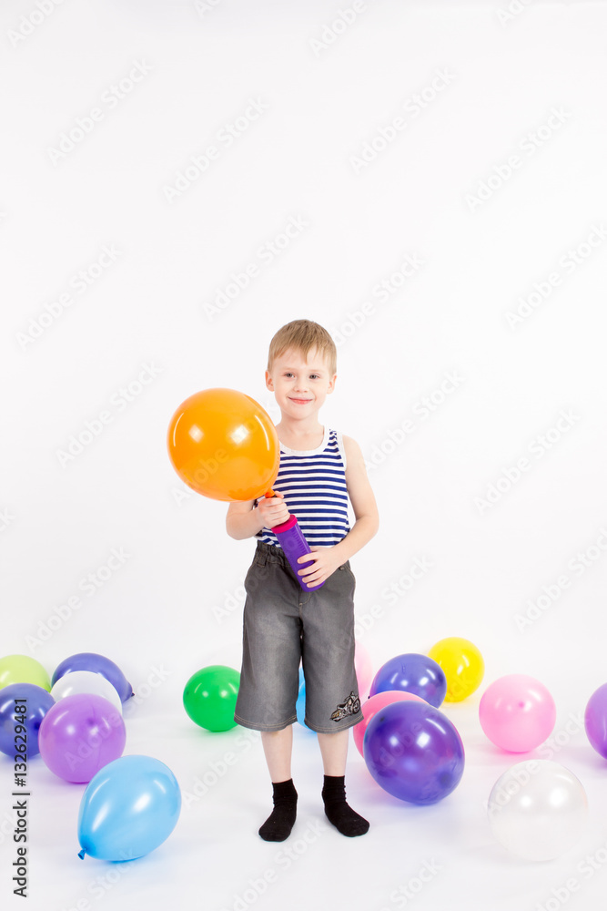 The little boy inflates the Balloon on the White Background The little boy inflates the Balloon on the White Background